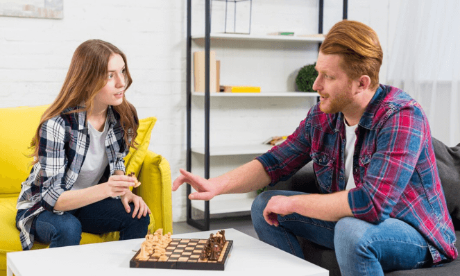 Two people playing chess to describe competitor intelligence.