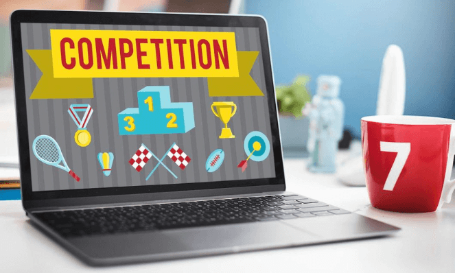 A laptop with the word "competition" written on it.